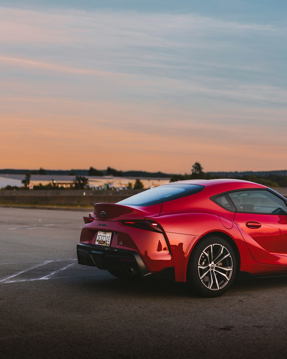 a red sports car parked in a parking lot