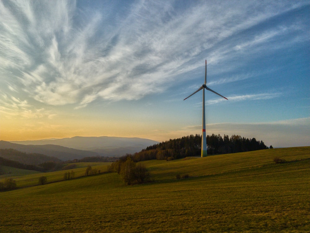 a wind turbine in the middle of a green field