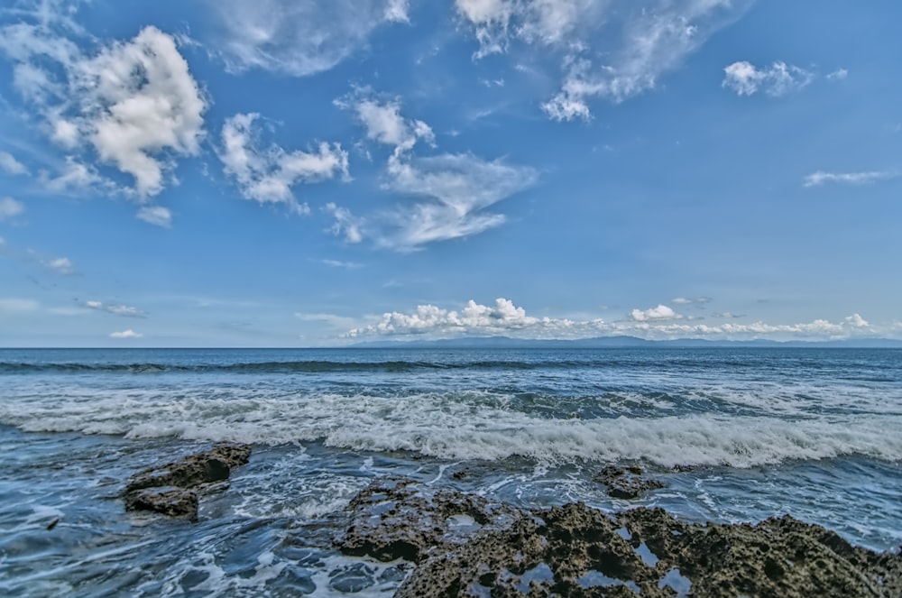 a view of the ocean from a rocky shore