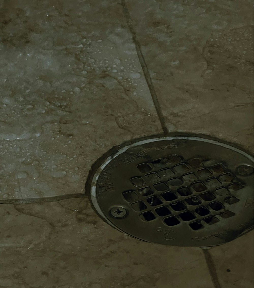 a drain in the floor of a bathroom