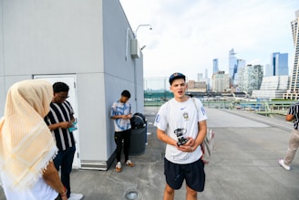 A group of friends dressed in Lumina Apparel gear enjoying a rooftop view of the city skyline.