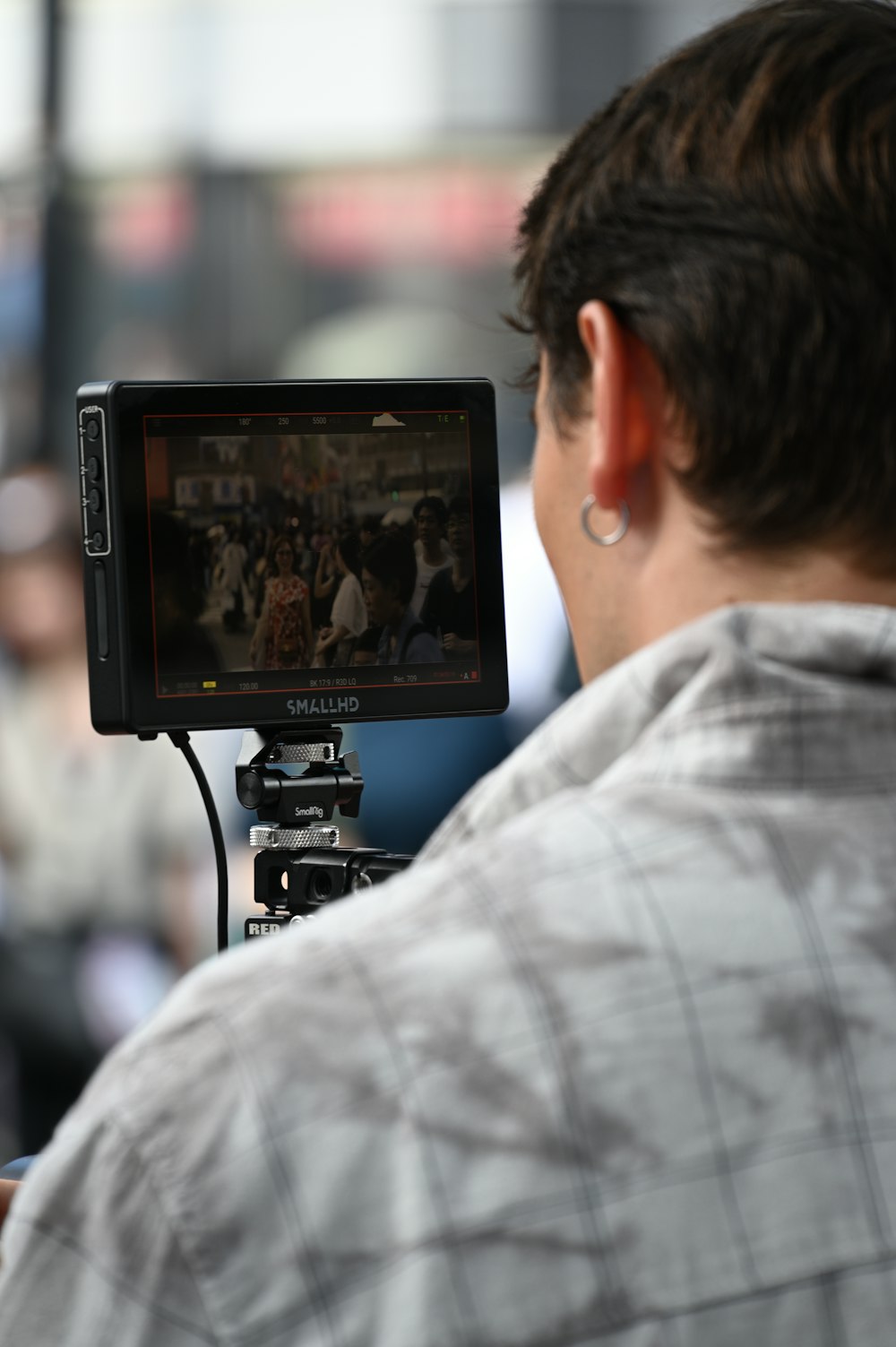 a man holding a video camera up to his face