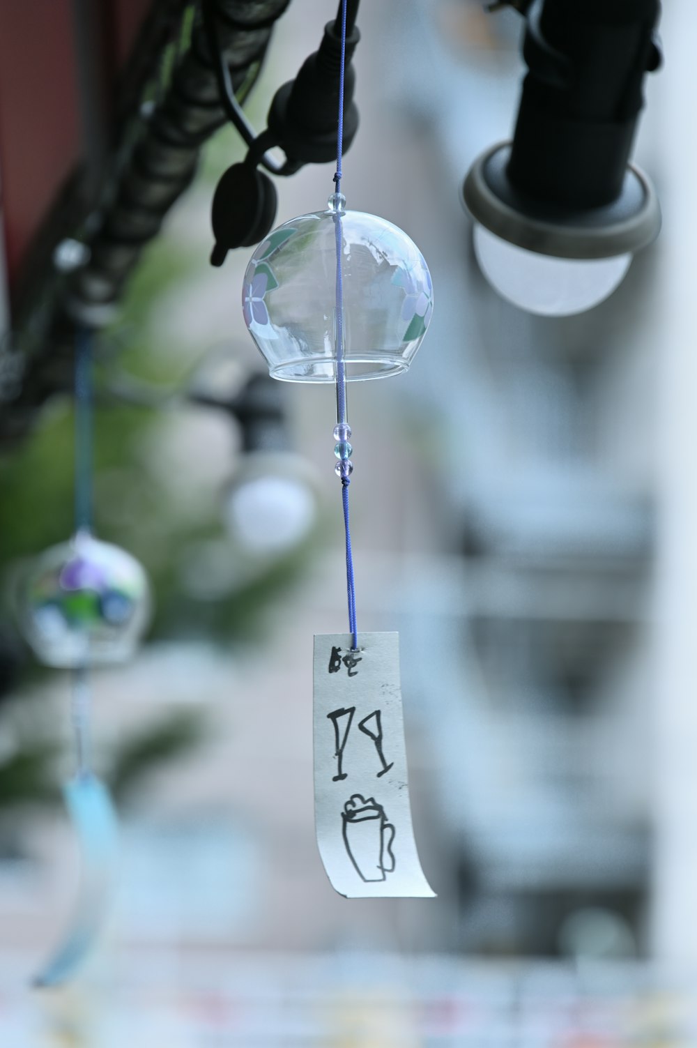 a close up of a wind chime hanging from a ceiling