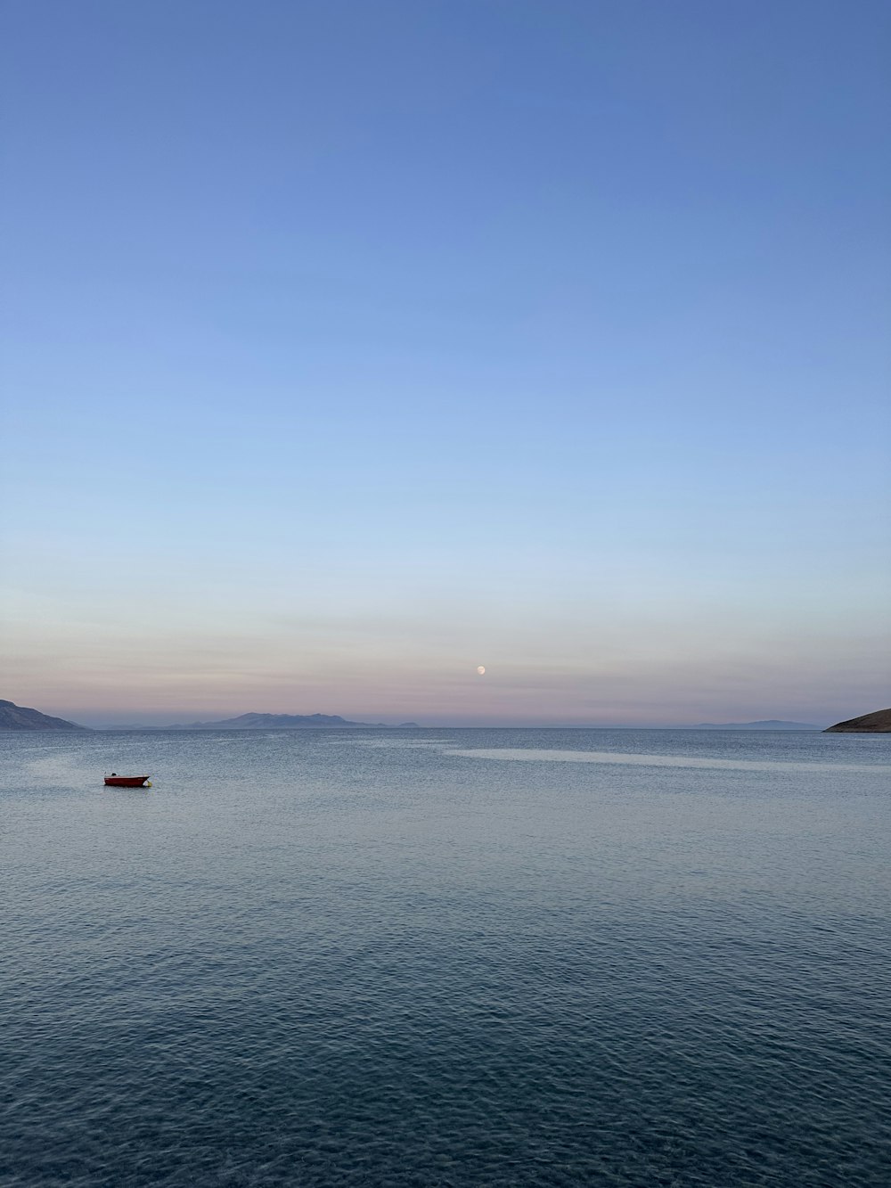 a boat floating on top of a large body of water