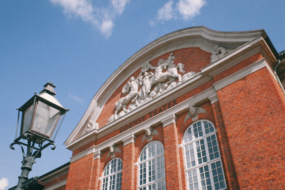 a red brick building with a lamp post in front of it