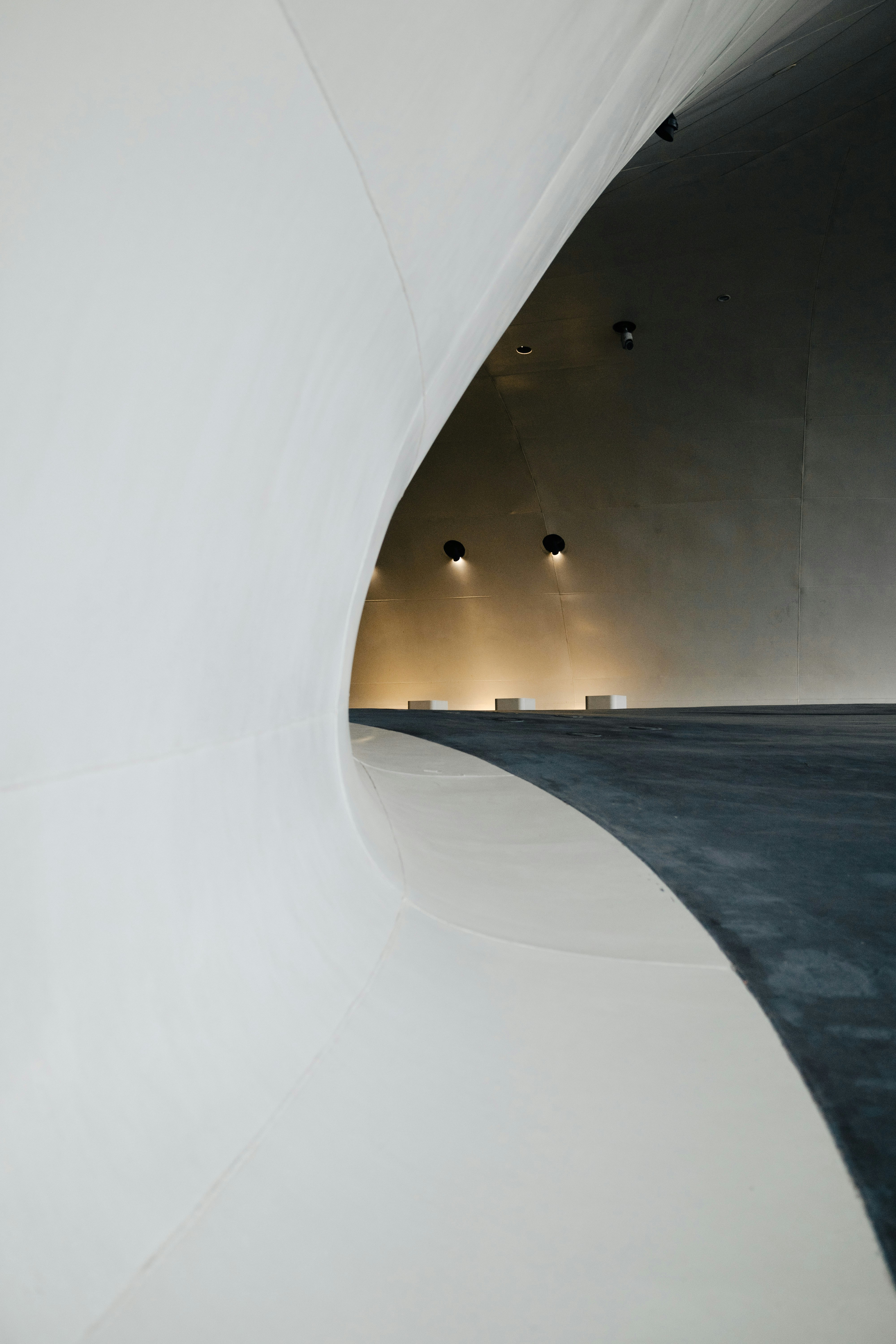 A large white building with a long curved wall photo – Free Wallpapers ...