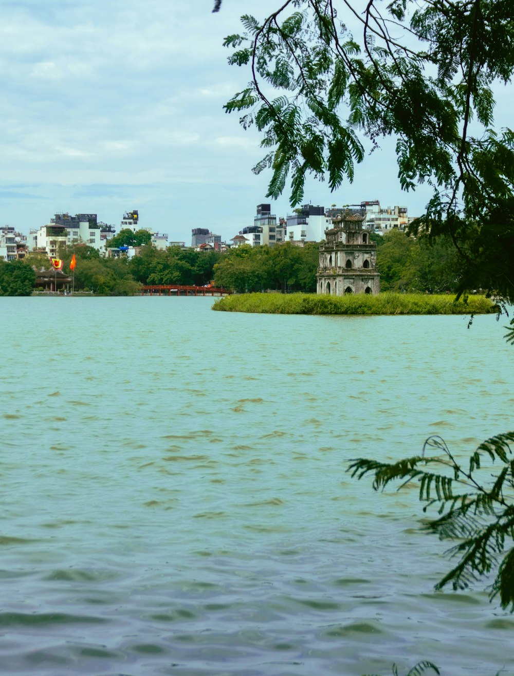 a body of water with a city in the background