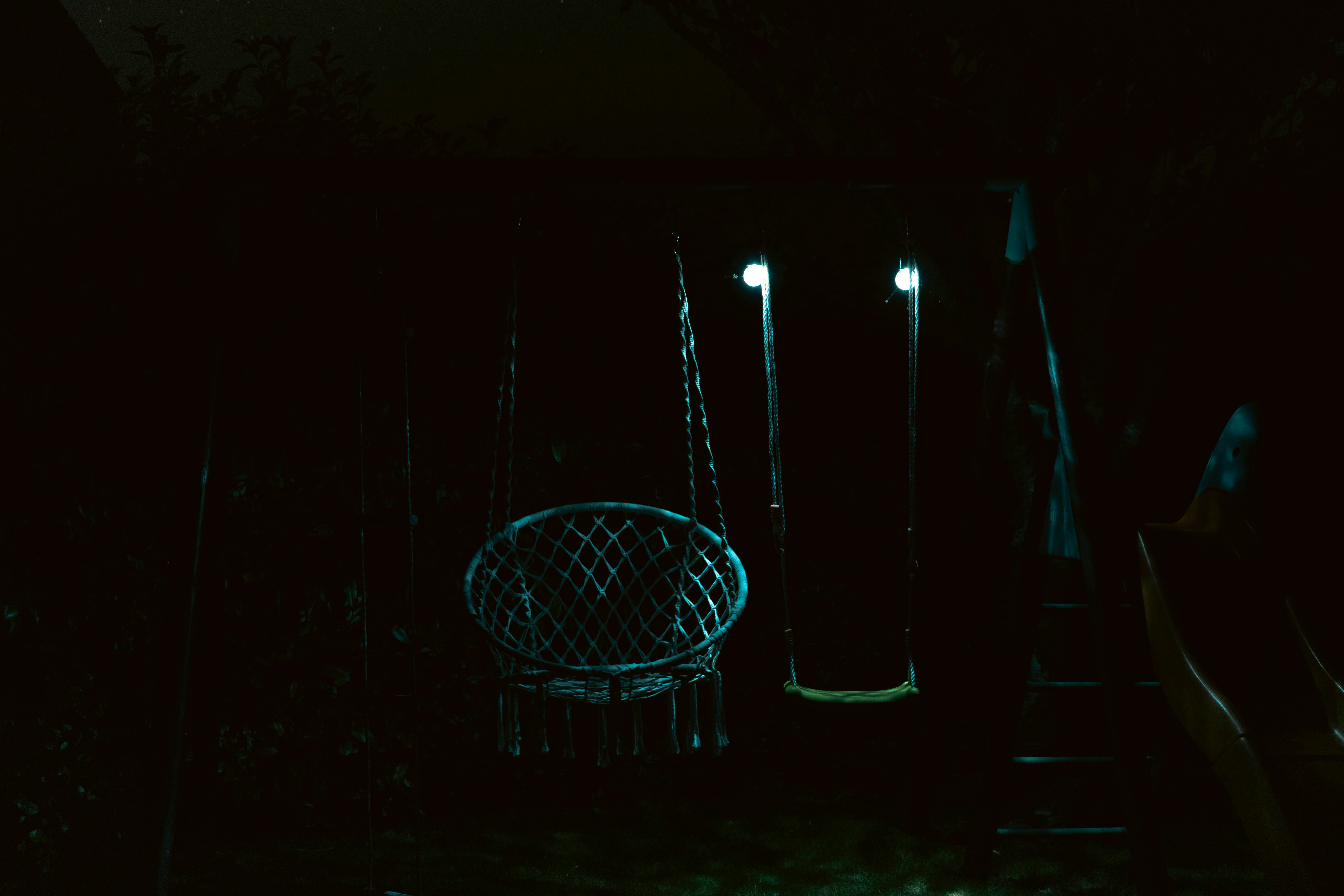 a chair sitting in the dark next to some lights