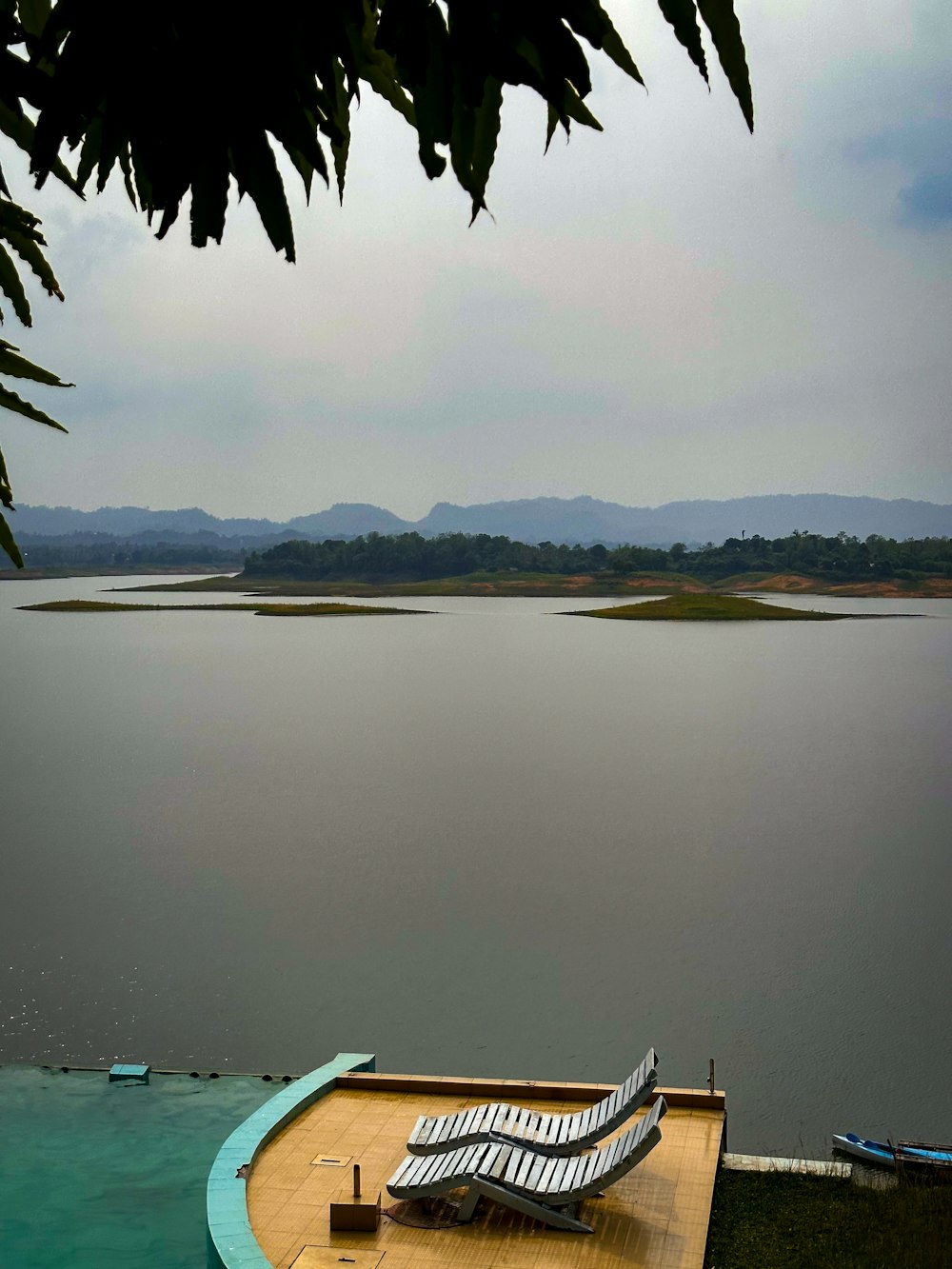 a boat sitting on top of a wooden dock next to a body of water