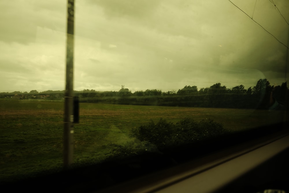 a view of a field from a train window