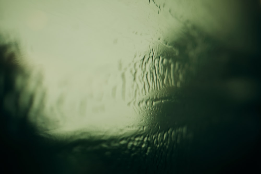 a close up of a window with rain drops on it