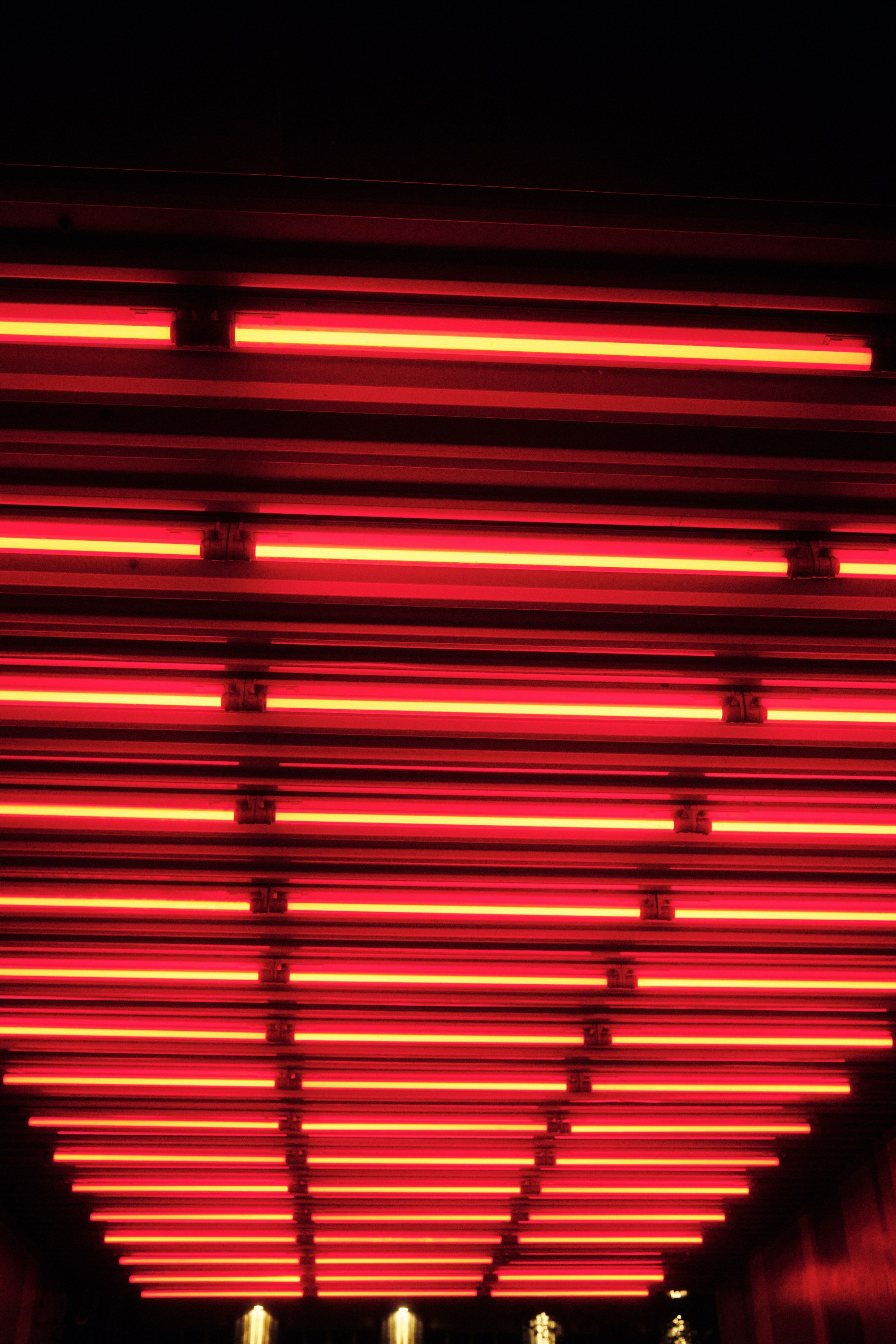 a red light that is on the side of a building