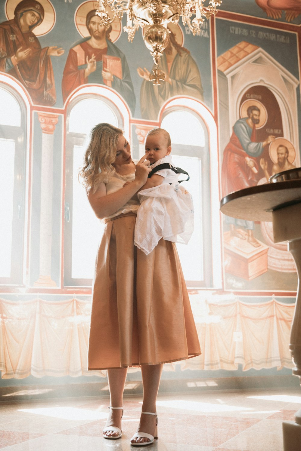 a woman holding a baby in her arms