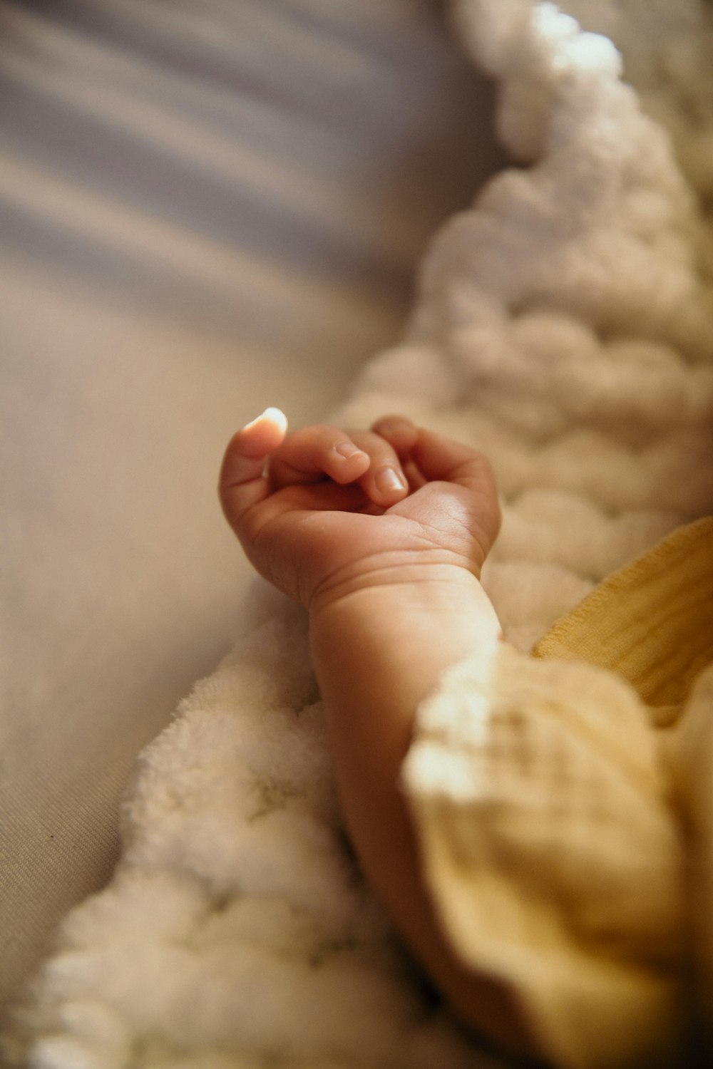 a close up of a baby laying on a bed