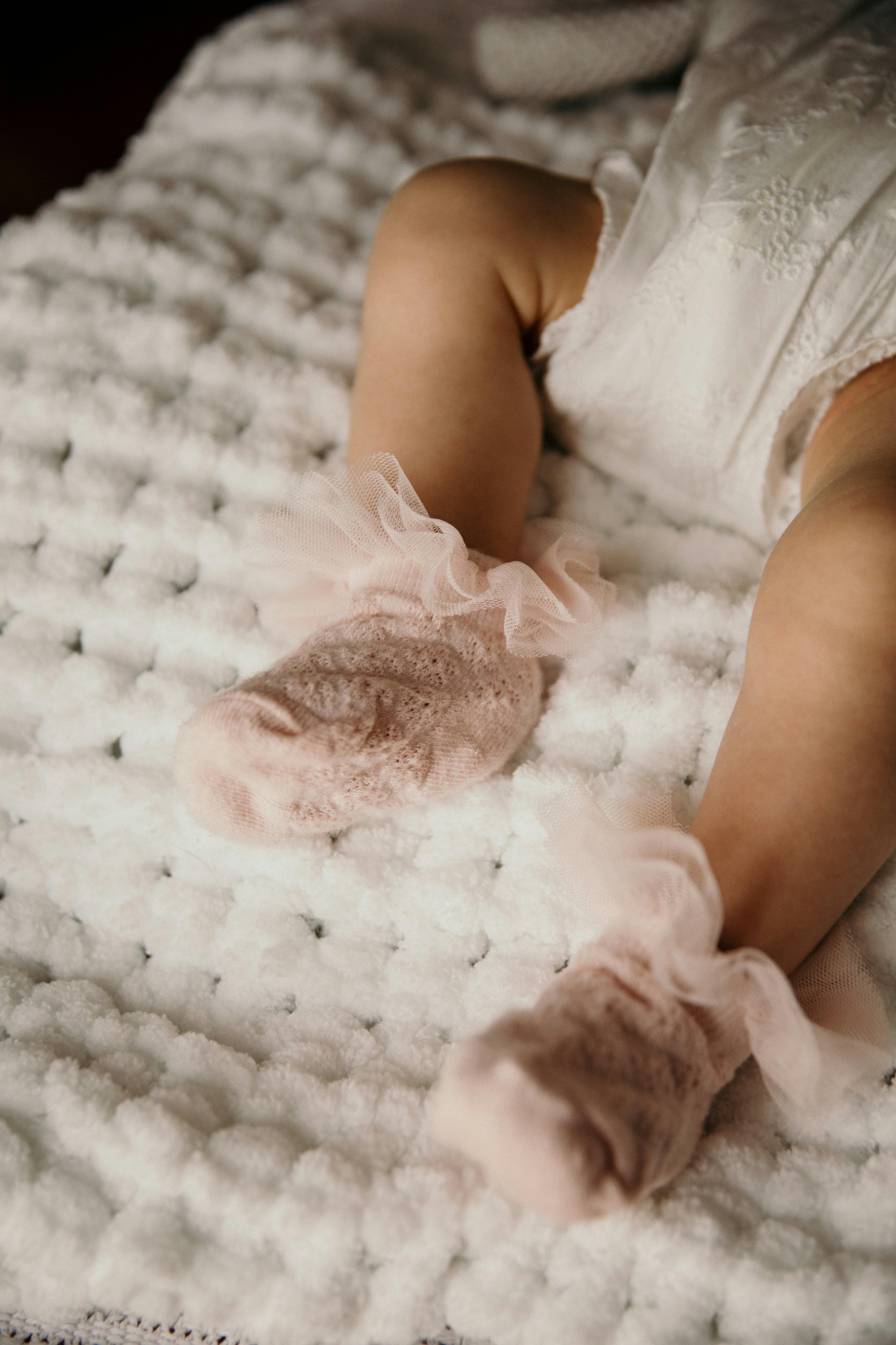 a baby is laying down on a blanket