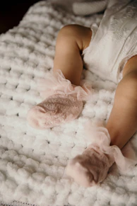 a baby is laying down on a blanket