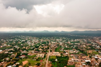 Aerial view of Faisal Town 2 showing wide carpeted roads and green spaces.