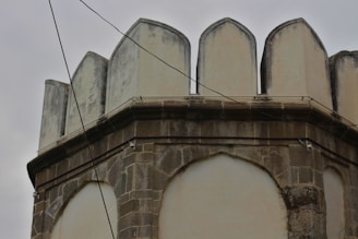 an old building with a clock on the top of it