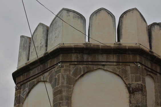 an old building with a clock on the top of it