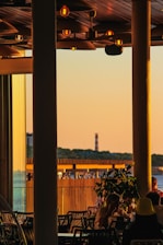 A cozy dining area overlooking the Cornwall coastline at sunset.