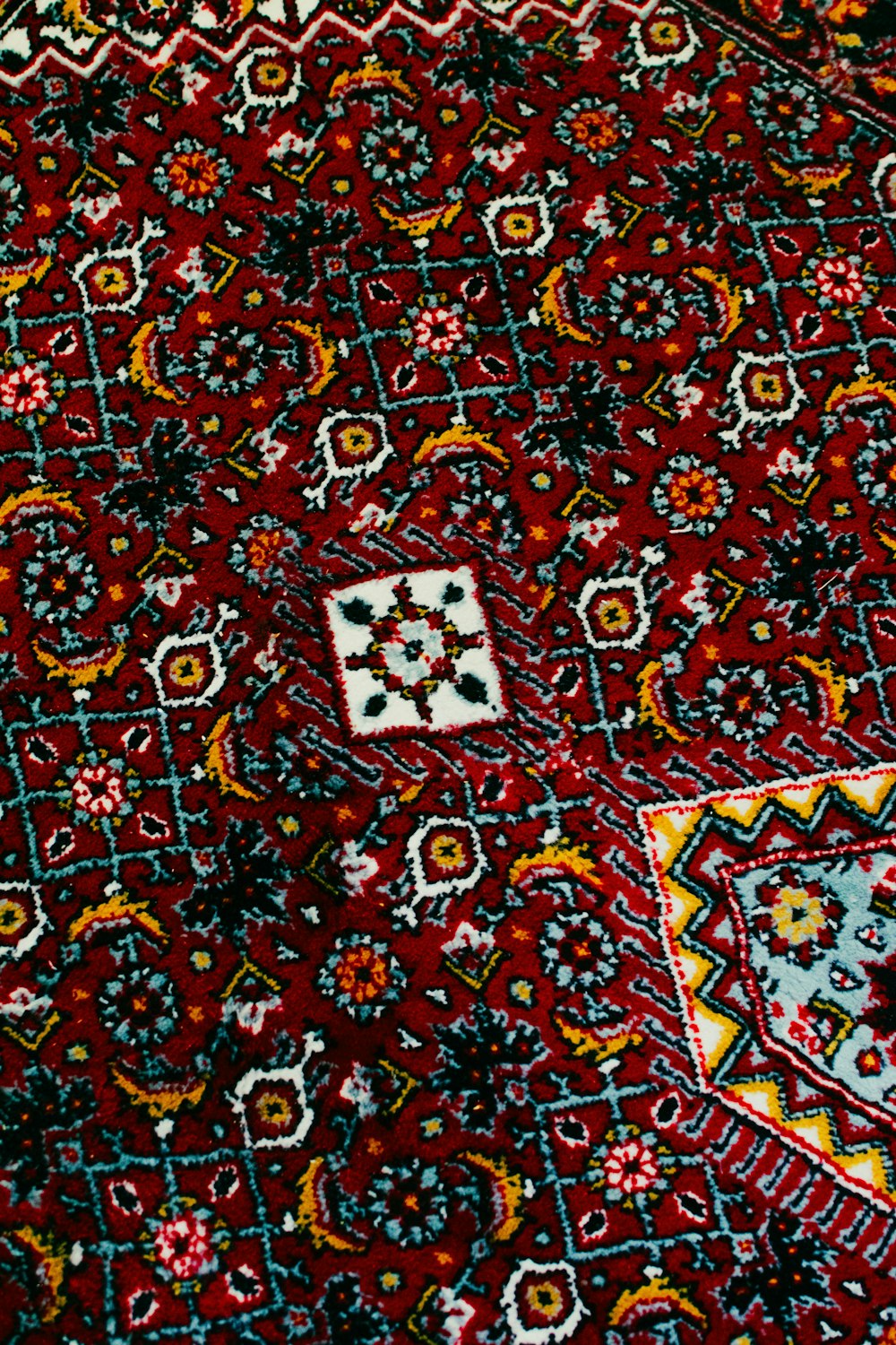 a close up of a red rug with a pattern on it
