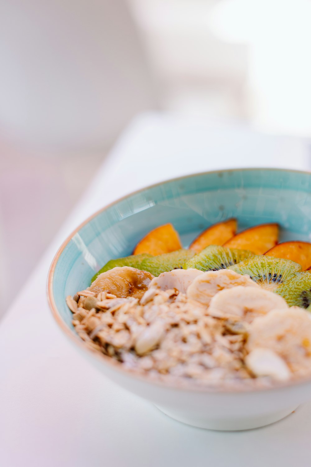 a bowl of oatmeal with kiwis, kiwis and