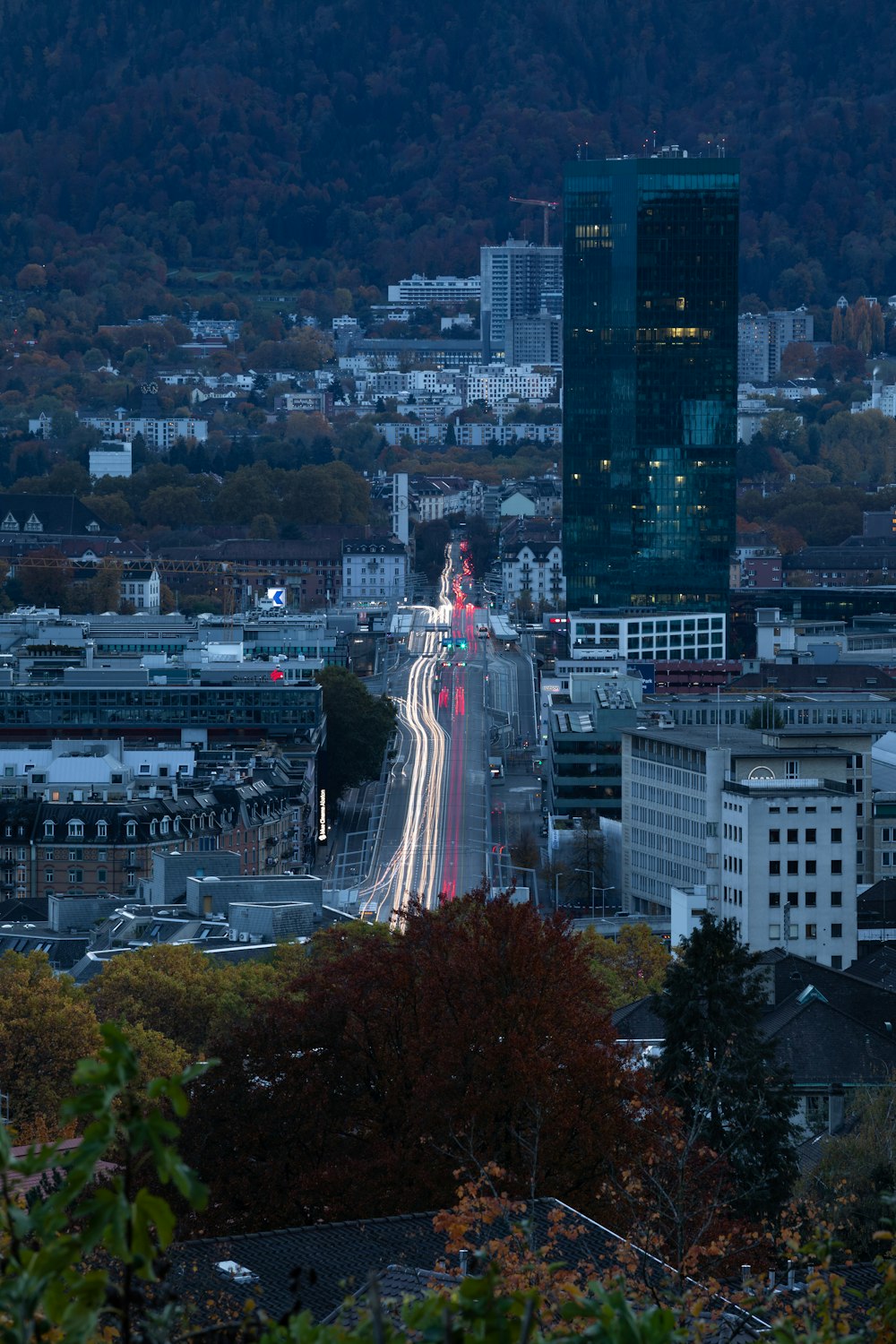 a view of a city at night from a hill