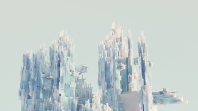 A digital rendering of towering geometric structures composed of translucent and glossy rectangles. The structures resemble a futuristic cityscape or abstract ice formations against a light, pastel background.