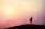 Person standing confidently on a hilltop at sunrise, symbolizing new beginnings