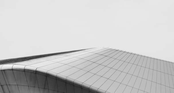 A sleek modern building with strong architectural lines under a dramatic sky