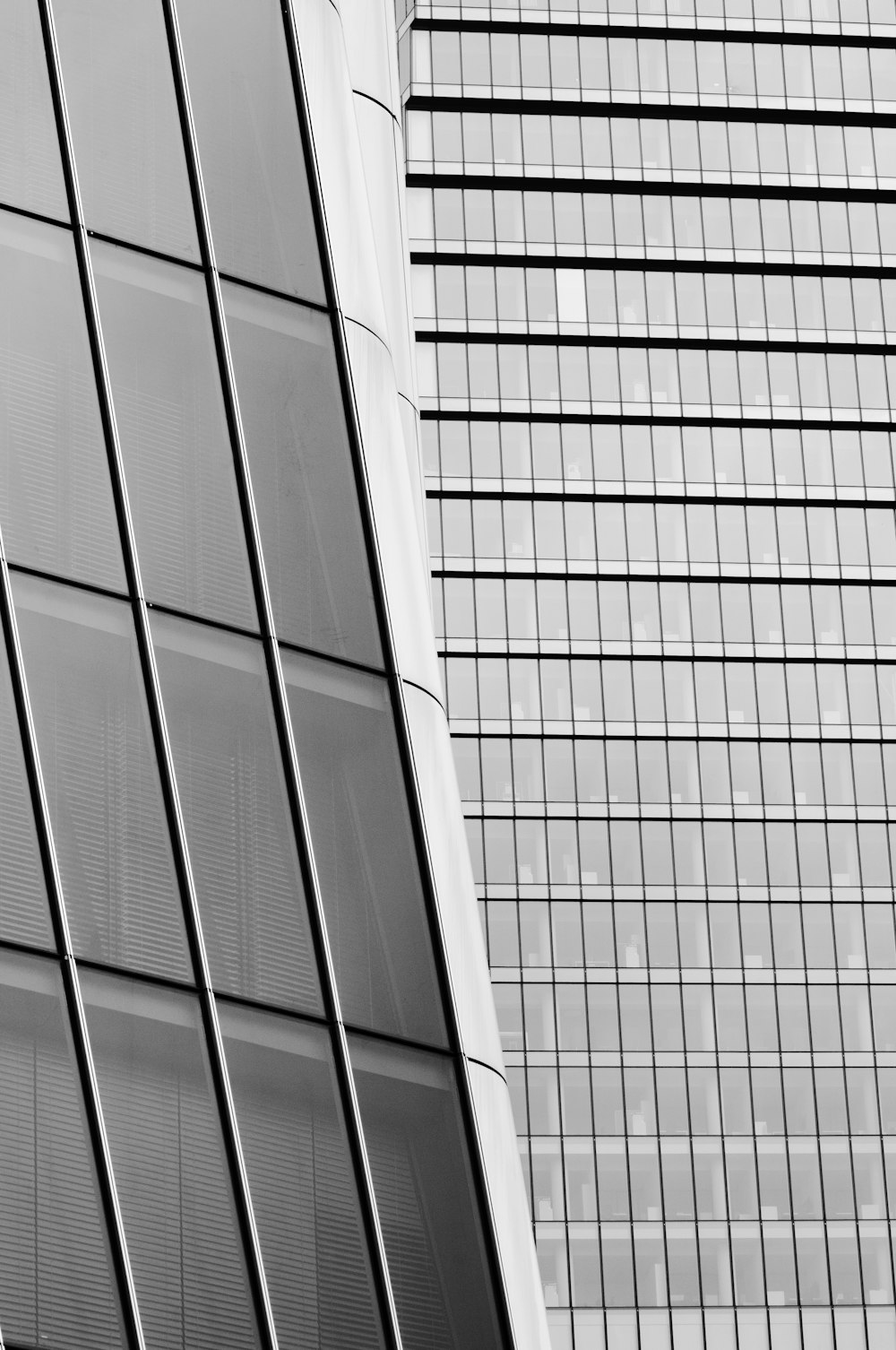 a black and white photo of two tall buildings