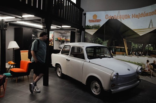 A professional appraiser examining a car's exterior for quality.