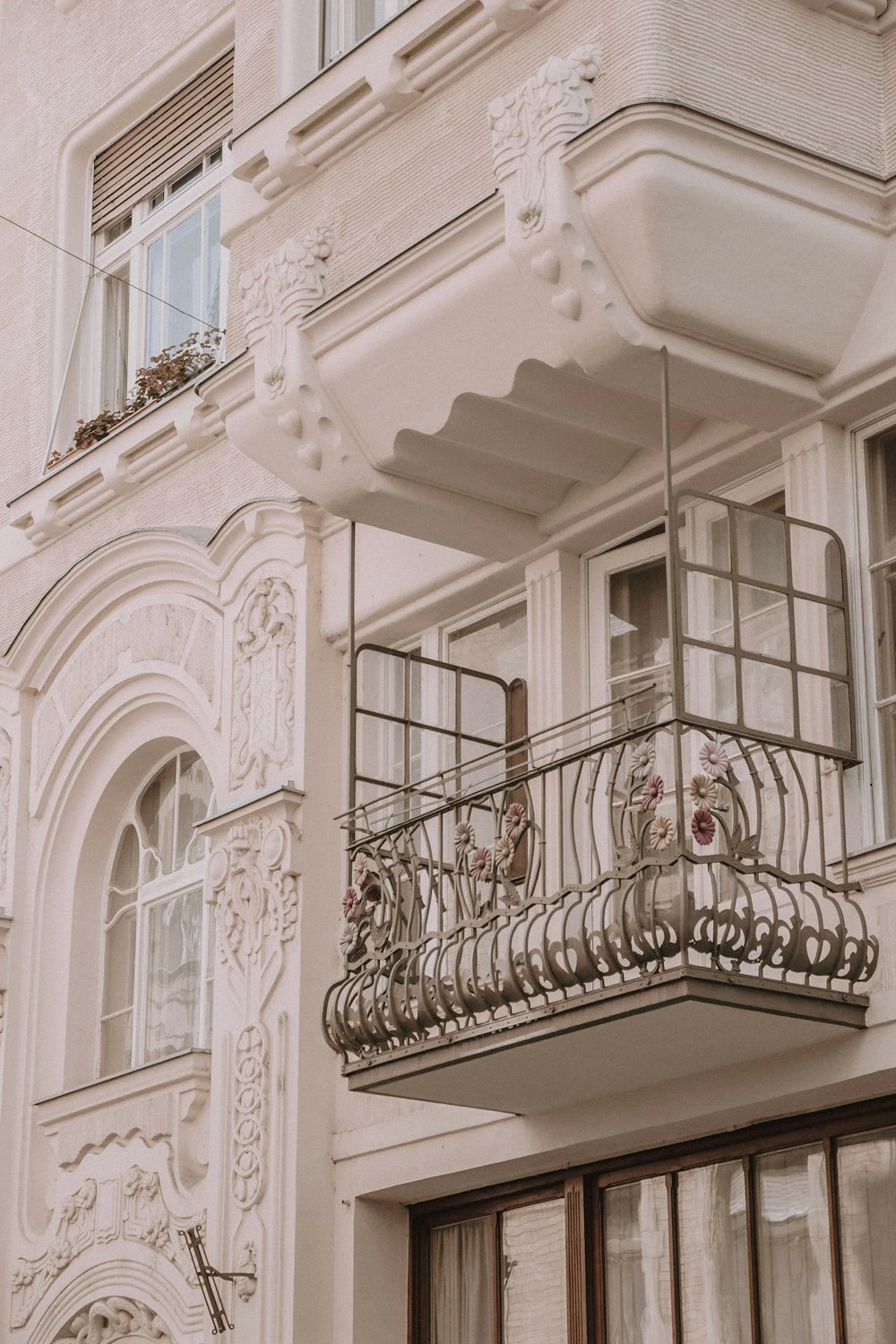 a building with a balcony and a clock on it