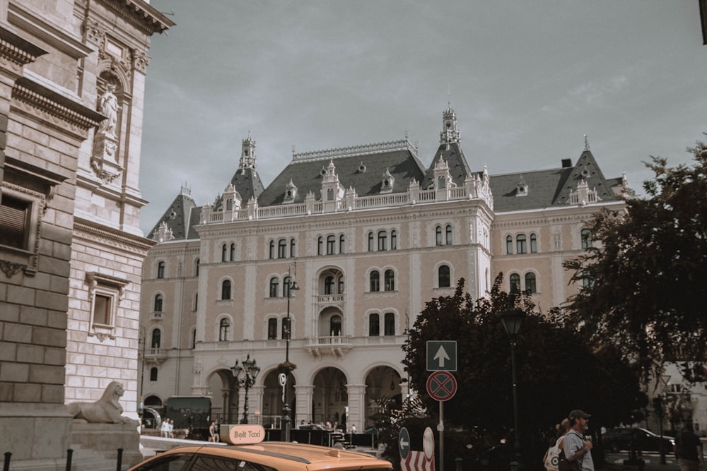 a taxi cab parked in front of a large building