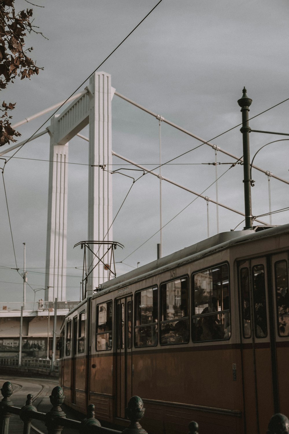 a train traveling down tracks next to a bridge