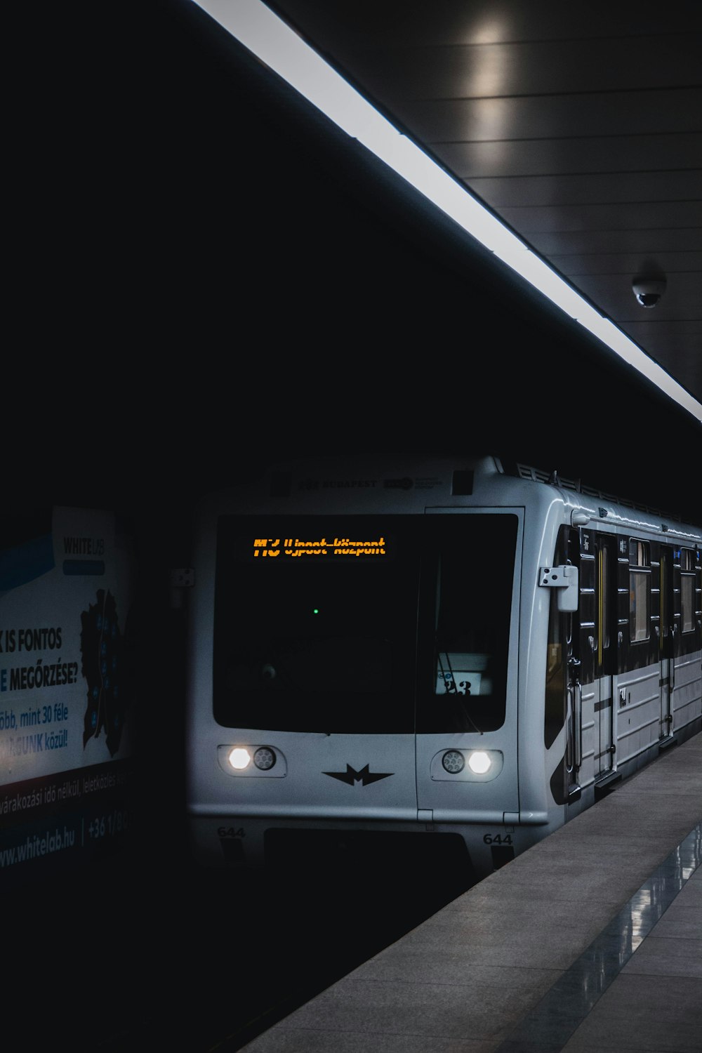a subway train pulling into a train station