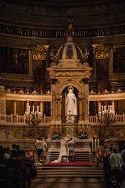 A beautifully decorated wedding altar with floral arrangements and soft lighting.