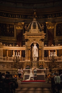 A beautifully decorated wedding altar with floral arrangements and soft lighting.