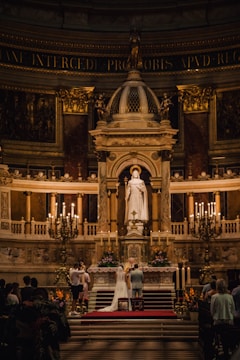A beautifully decorated wedding altar with soft floral arrangements and warm lighting.