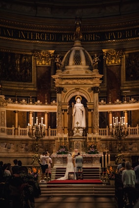 A serene wedding scene featuring a couple exchanging vows in a beautifully decorated church.