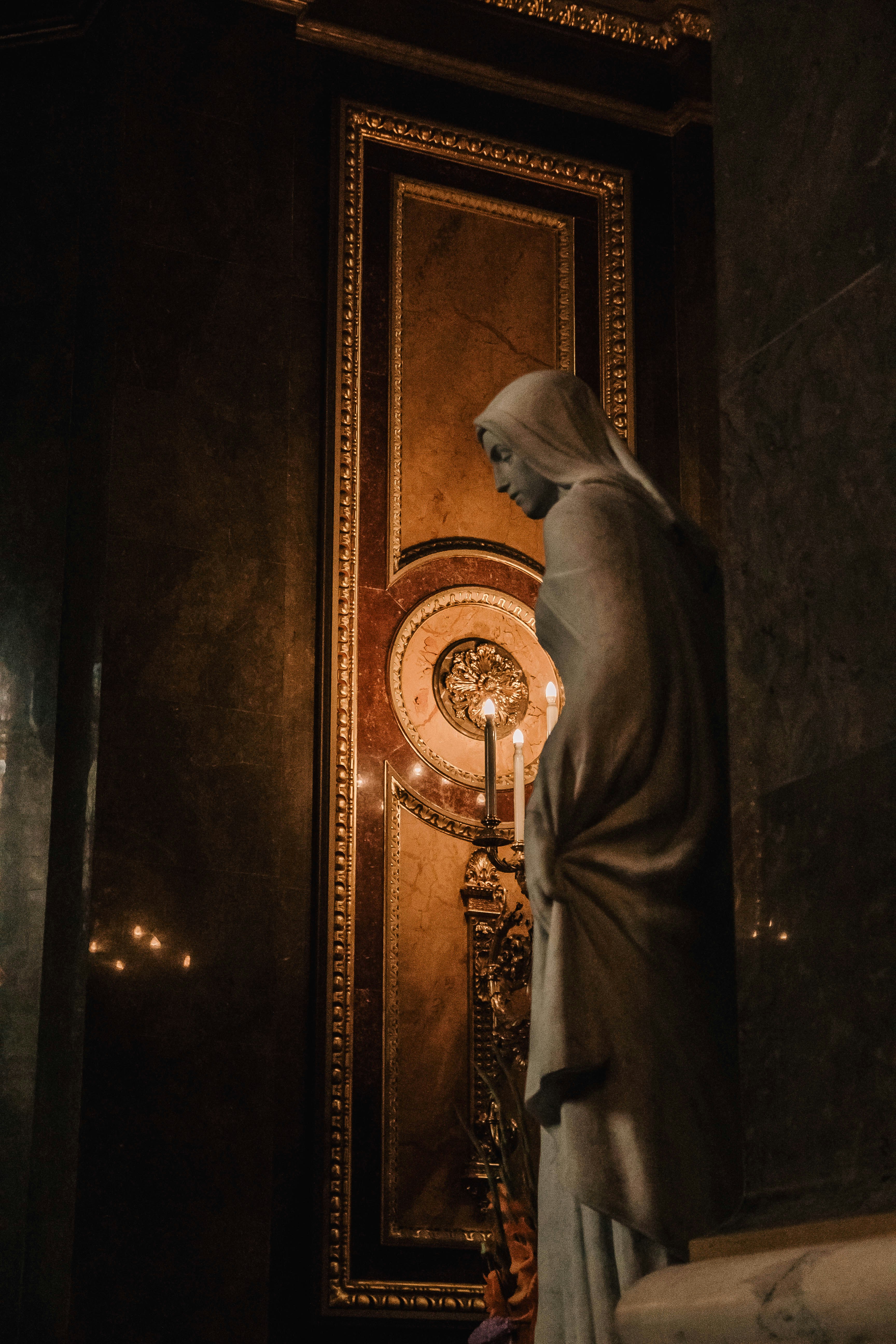 a statue of a woman standing in front of a door