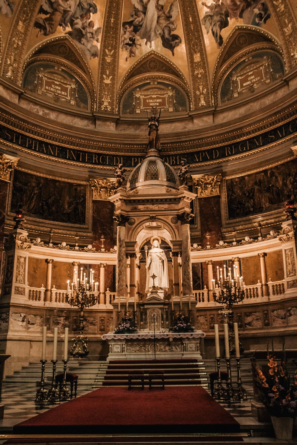 the interior of a church with a statue on the alter