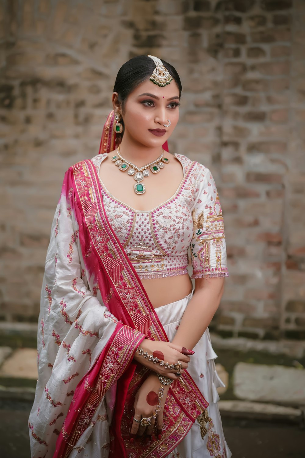 a woman in a white and pink bridal outfit