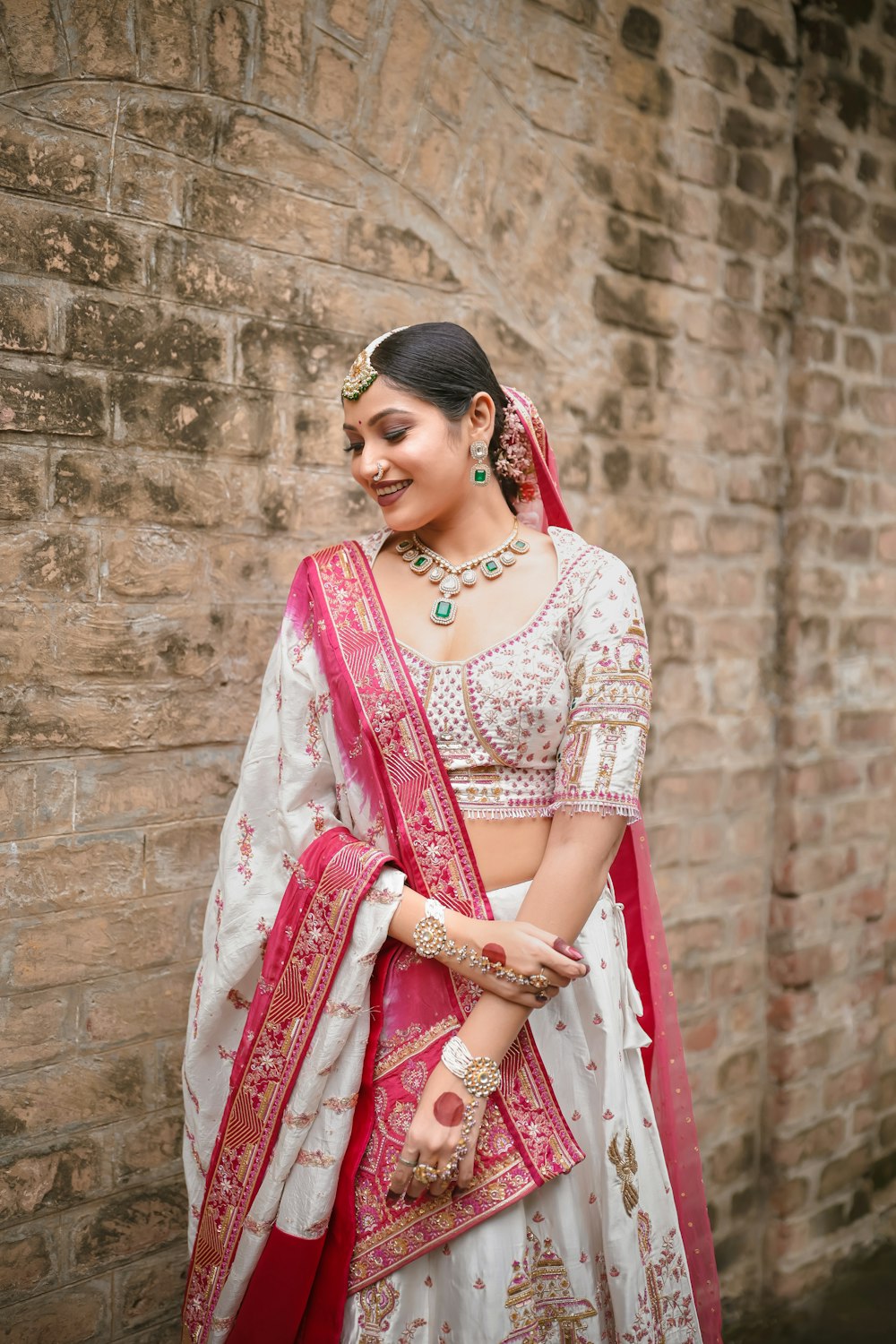 a woman in a white and red lehenga