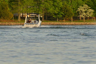Motorboat engine being carefully cleaned and serviced on a sunny day.