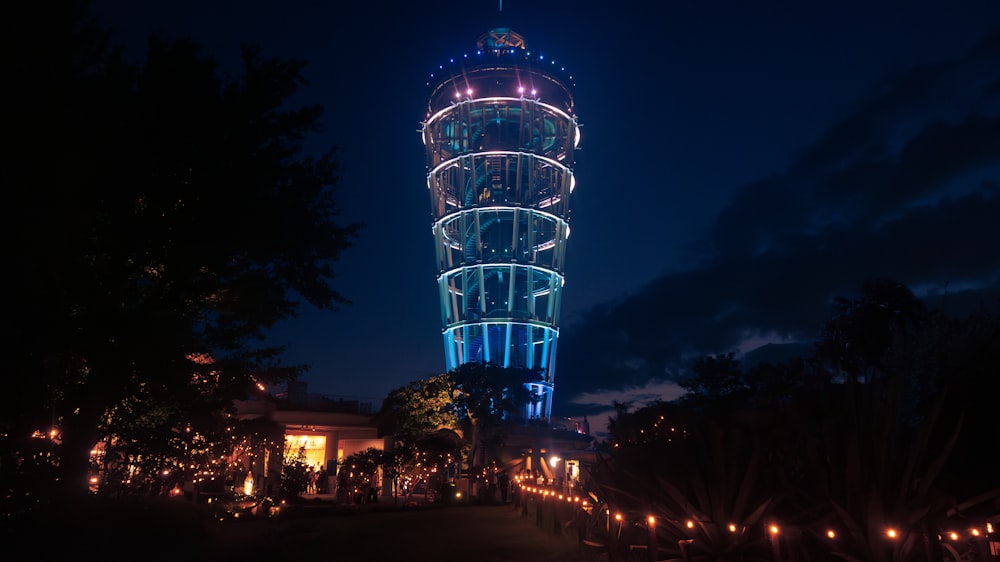 a tall tower lit up at night with lights