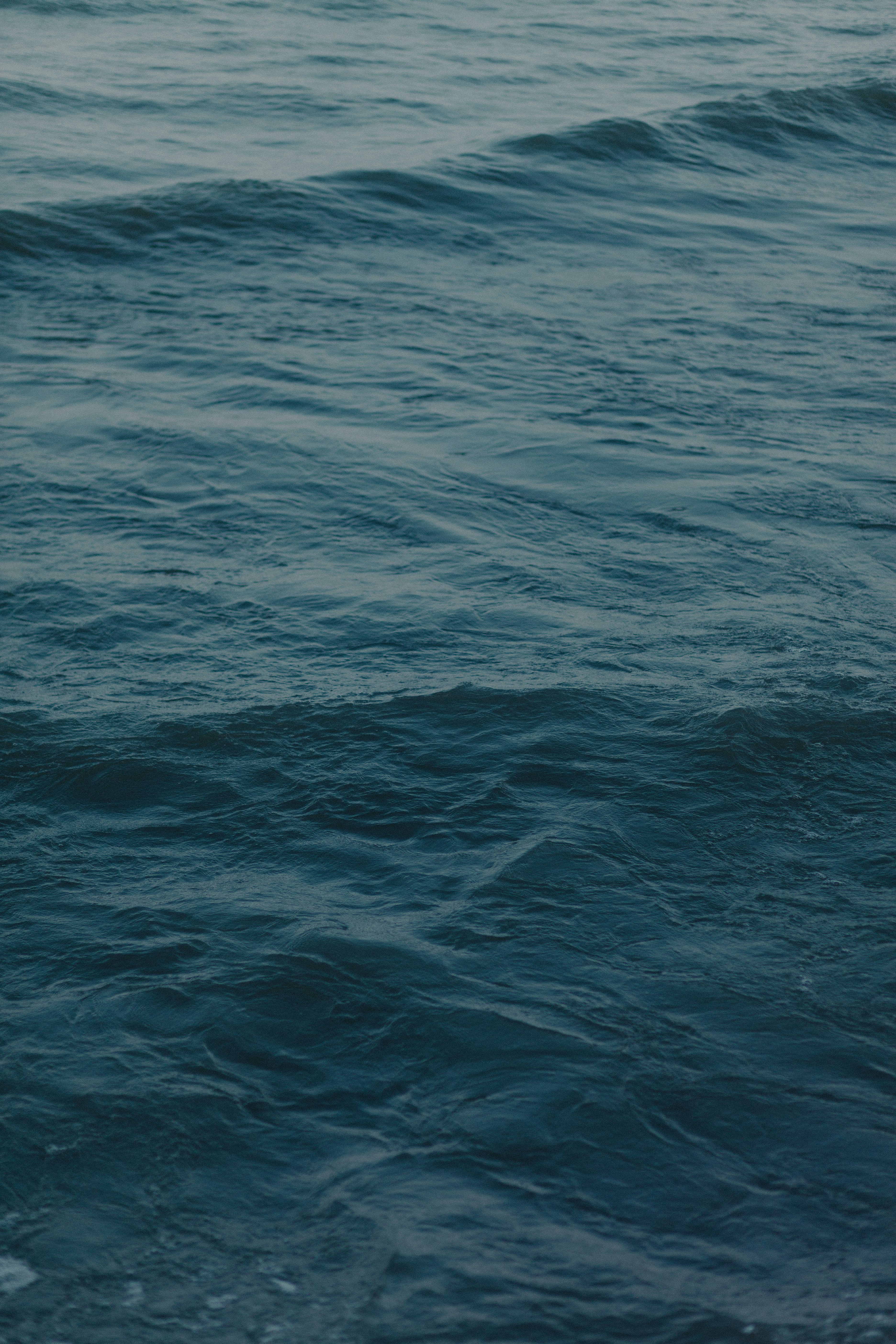 a person riding a surfboard on a wave in the ocean