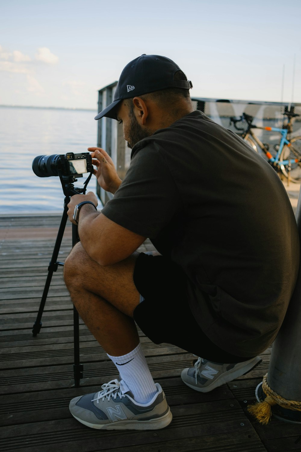 a man sitting on a dock with a camera