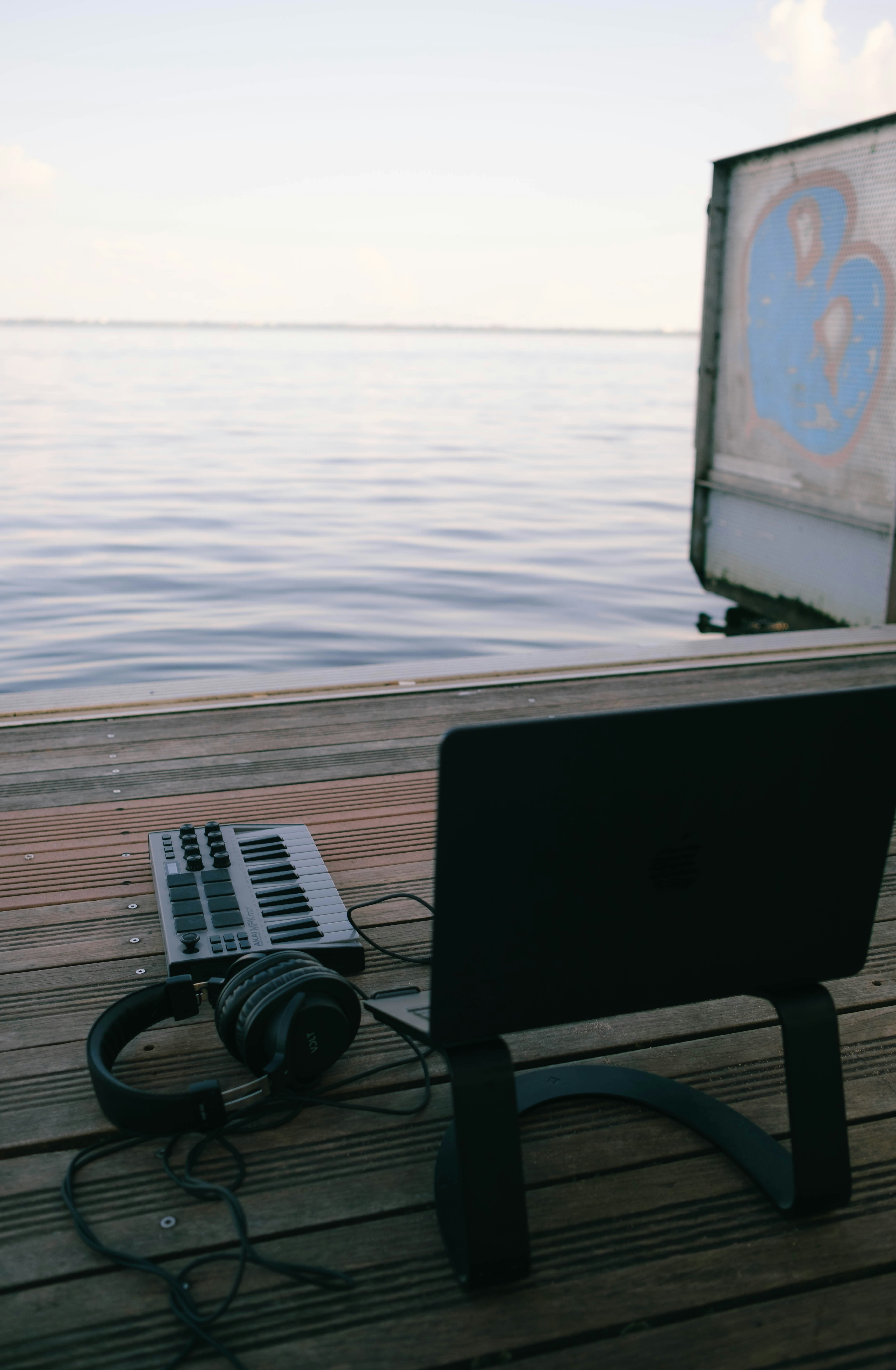 a laptop computer sitting on top of a wooden dock
