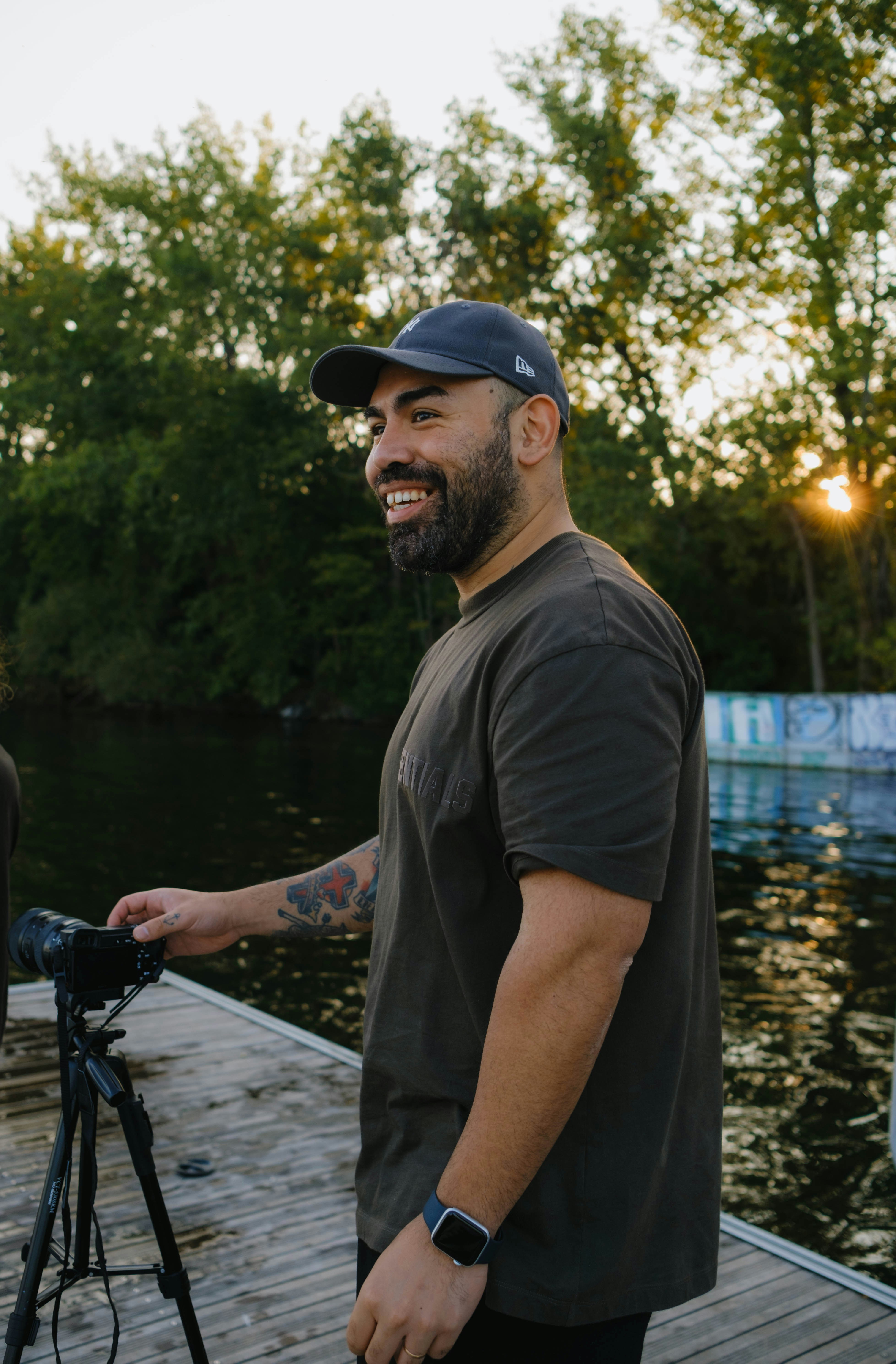 a man standing on a dock next to a camera